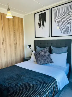 a bedroom with a large bed with two pillows at The Lagoon in Pretoria