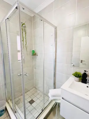 a bathroom with a shower and a sink at The Lagoon in Pretoria