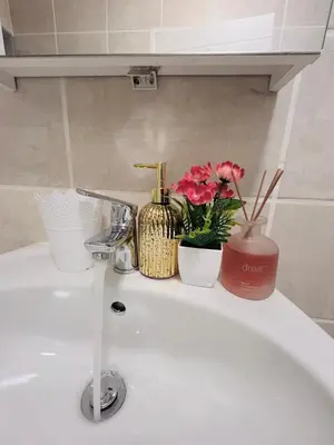 a bathroom sink with flowers on top of it at The Lagoon in Pretoria
