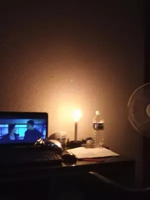 a desk with a laptop computer and a lamp at Charming 3 - Bedroom Home in Mangweni