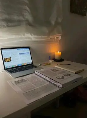 a laptop computer sitting on a table with a lit candle at Charming 3 - Bedroom Home in Mangweni
