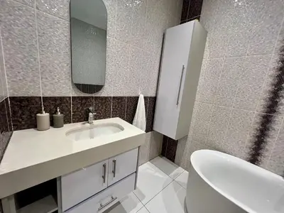 a bathroom with a sink and a toilet and a mirror at Vinorisa Spa & Lodge in Pretoria
