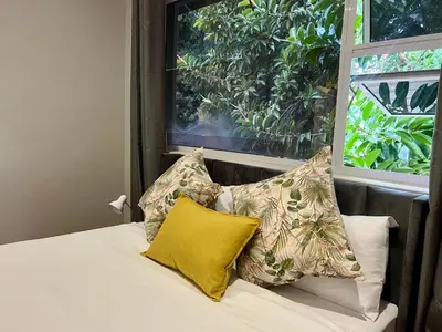 a bed with pillows and a window in a room at Vinorisa Spa & Lodge in Pretoria