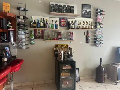 a bar with alcohol bottles on the wall at Kwa Ndosi in Polokwane