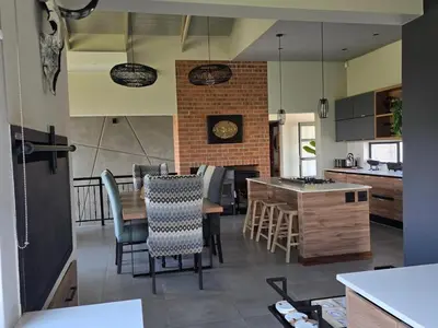 a kitchen and dining room with a table and chairs at Ironwood Manor in Dullstroom