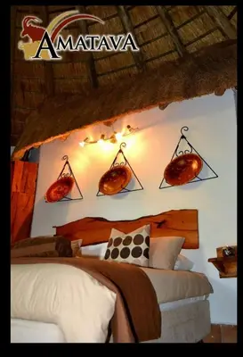 a bedroom with a bed and some food on the wall at Amatava Lodge in Mokopane