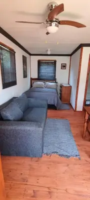 a living room with a couch and a bed at Amatava Lodge in Mokopane
