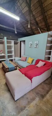 a large bedroom with two beds and a red blanket at Amatava Lodge in Mokopane