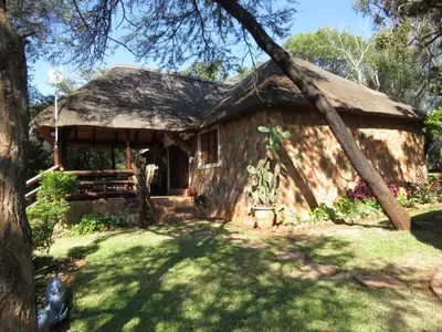 a small house with a grass roof at Amatava Lodge in Mokopane