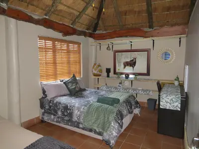 a bedroom with a bed and a window at Amatava Lodge in Mokopane