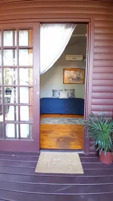 a front door of a house with a bed in it at Koshys Haven at Kruger in Malelane