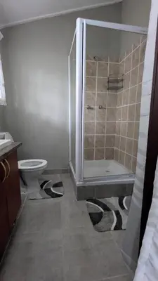 a bathroom with a shower and a toilet at Koshys Haven at Kruger in Malelane