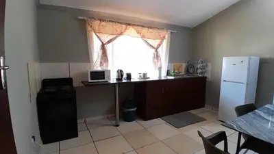 a kitchen with a desk with a computer and a window at Koshys Haven at Kruger in Malelane