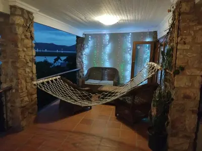 a hammock in a room with a view of the ocean at Wakanda on Hartbeespoort Dam in Hartbeespoort