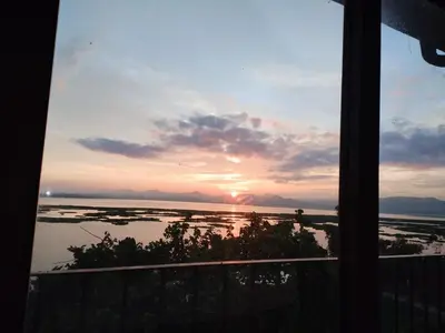 a view of a sunset from a window at Wakanda on Hartbeespoort Dam in Hartbeespoort