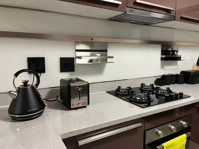 a kitchen with a stove and a tea kettle on a counter at Ambience Defined in Randjesfontein