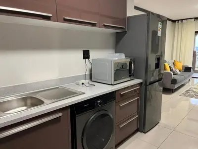 a kitchen with a sink and a microwave at Ambience Defined in Randjesfontein