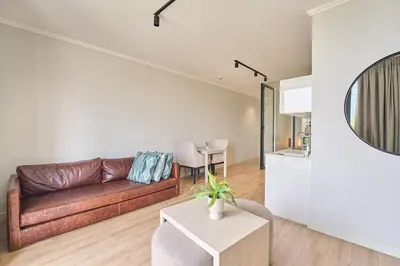 a living room with a couch and a table at MaZZ at Ellipse Waterfall in Midrand