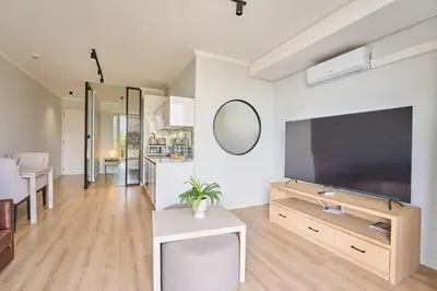 a living room with a large flat screen tv at MaZZ at Ellipse Waterfall in Midrand