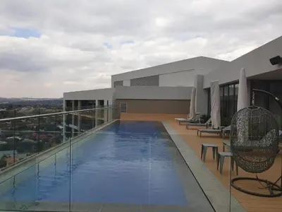 a swimming pool on the roof of a building at Menlyn Maine Trilogy Apartment 1101 in Pretoria