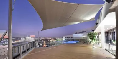 a balcony of a building with a view of a city at Menlyn Maine Trilogy Apartment 1101 in Pretoria
