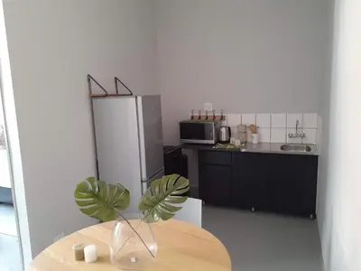 a kitchen with a table and a refrigerator at Luxury 3-Bedroom Apartment in Midrand in Midrand