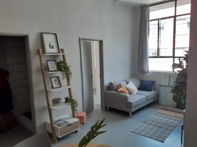 a living room with a couch and a window at Luxury 3-Bedroom Apartment in Midrand in Midrand