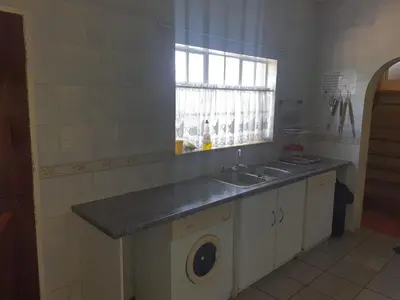 a kitchen with a sink and a window at Cynthias Country Farm Stay 5bedroom in Hartbeespoort