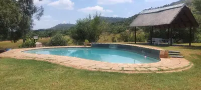 a swimming pool in a yard with a gazebo at Cynthias Country Farm Stay 5bedroom in Hartbeespoort