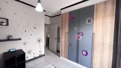 a room with a wall with dandelions on it at Family Elegant Smart Home in Midrand