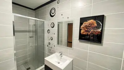 a bathroom with a sink and a shower and a mirror at Family Elegant Smart Home in Midrand