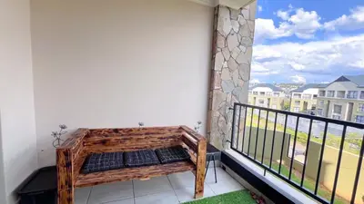 a balcony with a bench on the side of a building at Family Elegant Smart Home in Midrand