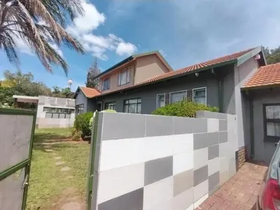 a house with a white fence in front of it at DAMOFUS Guest House in Pretoria