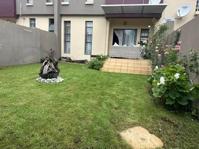 a yard with a house and some flowers at Cairo properties in Polokwane