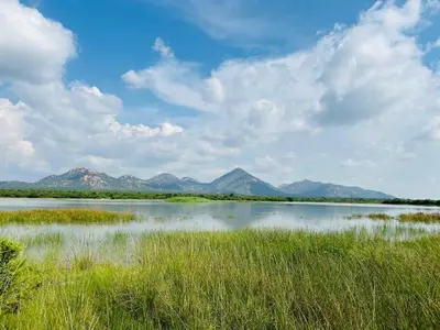 a large body of water with mountains in the background at Rooibok Gardens in Mokopane