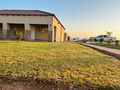 a house with a large yard in front of it at Rooibok Gardens in Mokopane