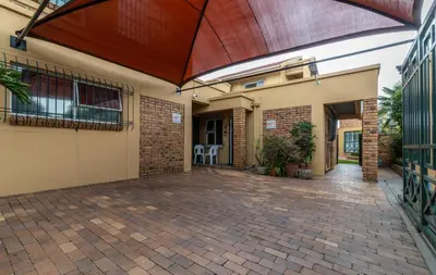 an empty courtyard of a house with a large patio at 210 Guest in Kempton Park