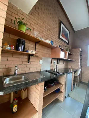 a kitchen with a sink and a brick wall at Mordern Lil' Love Nest Loft in Midrand in Midrand