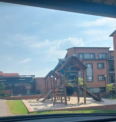 a playground with a slide in front of a building at Mordern Lil' Love Nest Loft in Midrand in Midrand