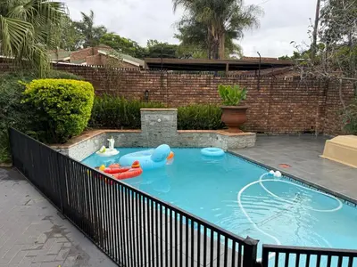 a swimming pool with a toy in a backyard at JuaMtoto guesthouse in Pretoria