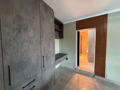 a kitchen with a large gray cabinet and a hallway at JuaMtoto guesthouse in Pretoria