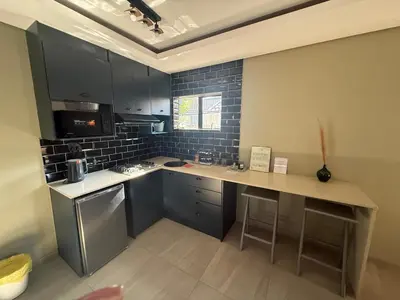 a kitchen with blue cabinets and a counter top at JuaMtoto guesthouse in Pretoria