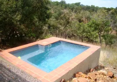 a swimming pool in the middle of a field at Valley View Elements 4 Bedroom in Warmbaths