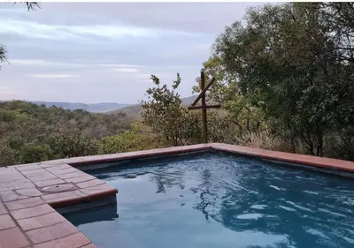 a swimming pool with a cross on top of it at Valley View Elements 4 Bedroom in Warmbaths
