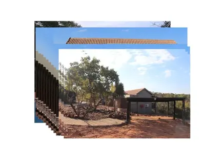 a fence with a house in the background at Valley View Elements 4 Bedroom in Warmbaths
