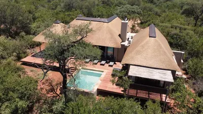 an overhead view of a house with a thatch roof at Villa White Lion - Luxurious Villa nearby Kruger in Hoedspruit