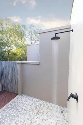 a shower with water coming out of it at Villa White Lion - Luxurious Villa nearby Kruger in Hoedspruit