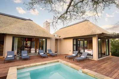 a villa with a swimming pool and a patio at Villa White Lion - Luxurious Villa nearby Kruger in Hoedspruit