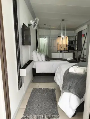a hotel room with two beds and a kitchen at 20 on Middle in Polokwane