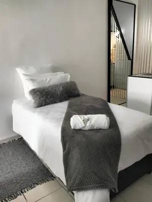 a bedroom with a bed with two towels on it at 20 on Middle in Polokwane